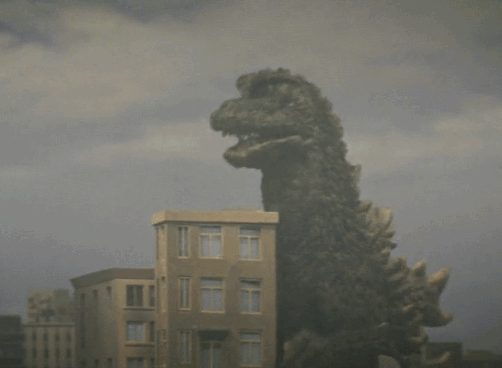 Godzilla destroying a model building