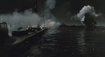 Godzilla's spines flash before he unleashes a beam of atomic breath that destroys the entire military defense line