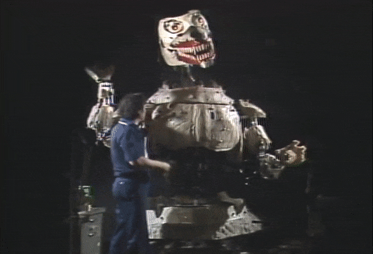 An unfinished robotic Godzilla looks skeletal as it opens its mouth and moves its head and arms