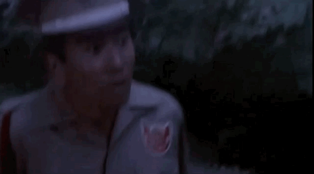 Man looks up, the camera following his gaze from toes to head of Godzilla