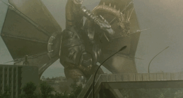 Mecha King Ghidorah appears crackling with energy as the camera focuses on his head, wings, then feet