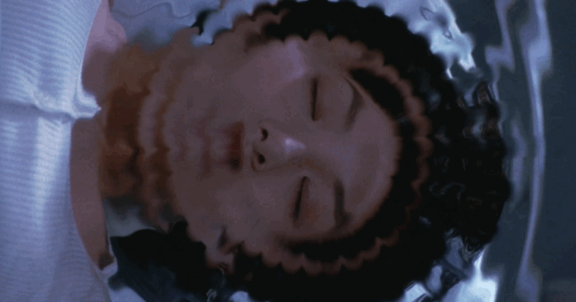 Miki levitates her bed into the air giving Shinjo a shot at the mobster's legs below