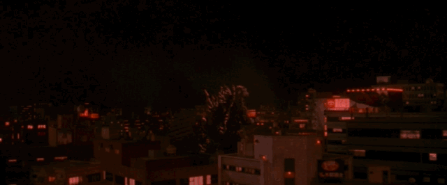 Godzilla charges his dorsal plates before firing atomic breath in a circle around him