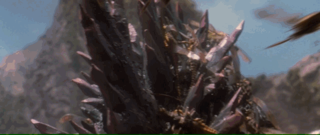 Bugs swarm around Godzilla and he fries several of them when his spines glow before unleashing an atomic beam