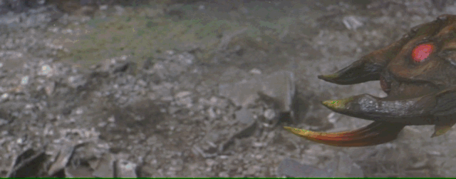 Godzilla's tail grabs Megaguirus's stinger and he slams her into the ground and throws her into a building