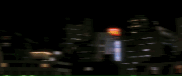 Mothra speedily flies through a cityscape, narrowly keeping pace ahead of Godzilla's atomic beam