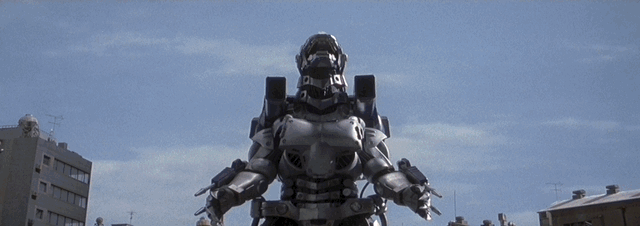 Kiryu launches a barrage of missiles destroying a huge section of the city