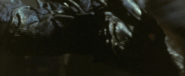 Godzilla tears two of Kaizer Ghidorah's three heads off before using the last to flip him into a pile of rubble