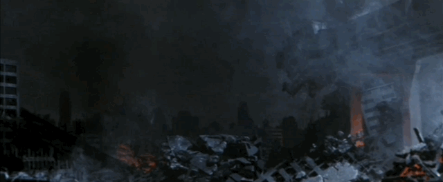 City wreckage around a large crater with Godzilla small in the center, Monster X ominously floats down behind him